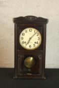 An early 20th century carved pine mantle clock the white dial with black painted Arabic numerals,