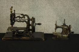 A sewing machine and a Muller child's toy sewing machine. Both crank operated. The larger of the