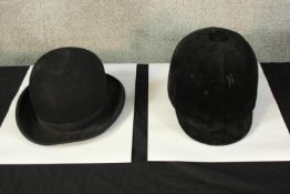 Bowler hat made by Gieves, London. With adjustable band. Also, a horse riding helmet.