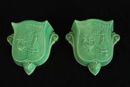 A pair of English Art Deco pottery green crackle glaze wall pockets decorated lady with geese,
