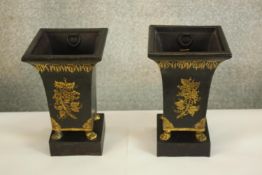 Two small urns decorated in gilt resting on marble plinths. Each 20 high x 13 cm.