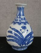 A blue and white century Chinese Ming style hand painted ceramic onion shaped bottle vase