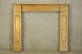 A pine fire surround. A simple design with a shallow shelf. Probably Edwardian. H.109 W.125cm.
