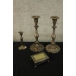 A pair of repousse foliate design silver plated candle sticks along with a smaller one with