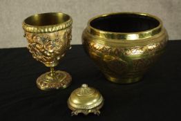 A collection of brass. One chalice with relief decoration, a bowl and a push bell. H.15cm (largest).