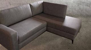 Corner sofa, contemporary in fabric upholstery on metal supports. W.225 D.95cm.