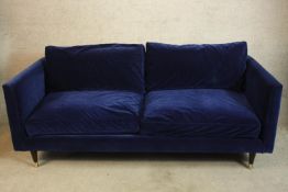 A contemporary blue upholstered two seater settee. H.71 W.200cm.