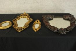 A miscellaneous collection of four small mirrors, carved and gilt wood. H.47 W.52cm (largest).