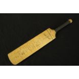 Mini cricket bat hand signed by English cricketers , including Colin Cowdrey, on the back. On the