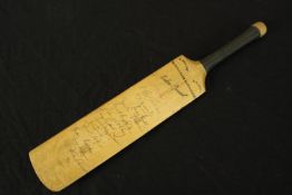 Mini cricket bat hand signed by English cricketers , including Colin Cowdrey, on the back. On the