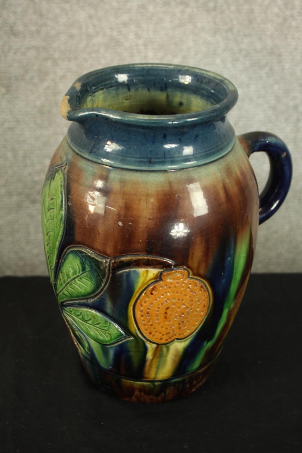 Three studio pottery jugs. Two with a floral decoration. H.30cm (largest). - Image 4 of 5