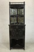 A Victorian Aesthetic movement ebonised corner cabinet with a gallery top over a shelf flanked by