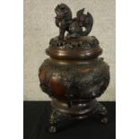 A Japanese bronze censer with lid. The lid with a Foo dog finial. With maker's seal on the base.