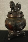 A Japanese bronze censer with lid. The lid with a Foo dog finial. With maker's seal on the base.