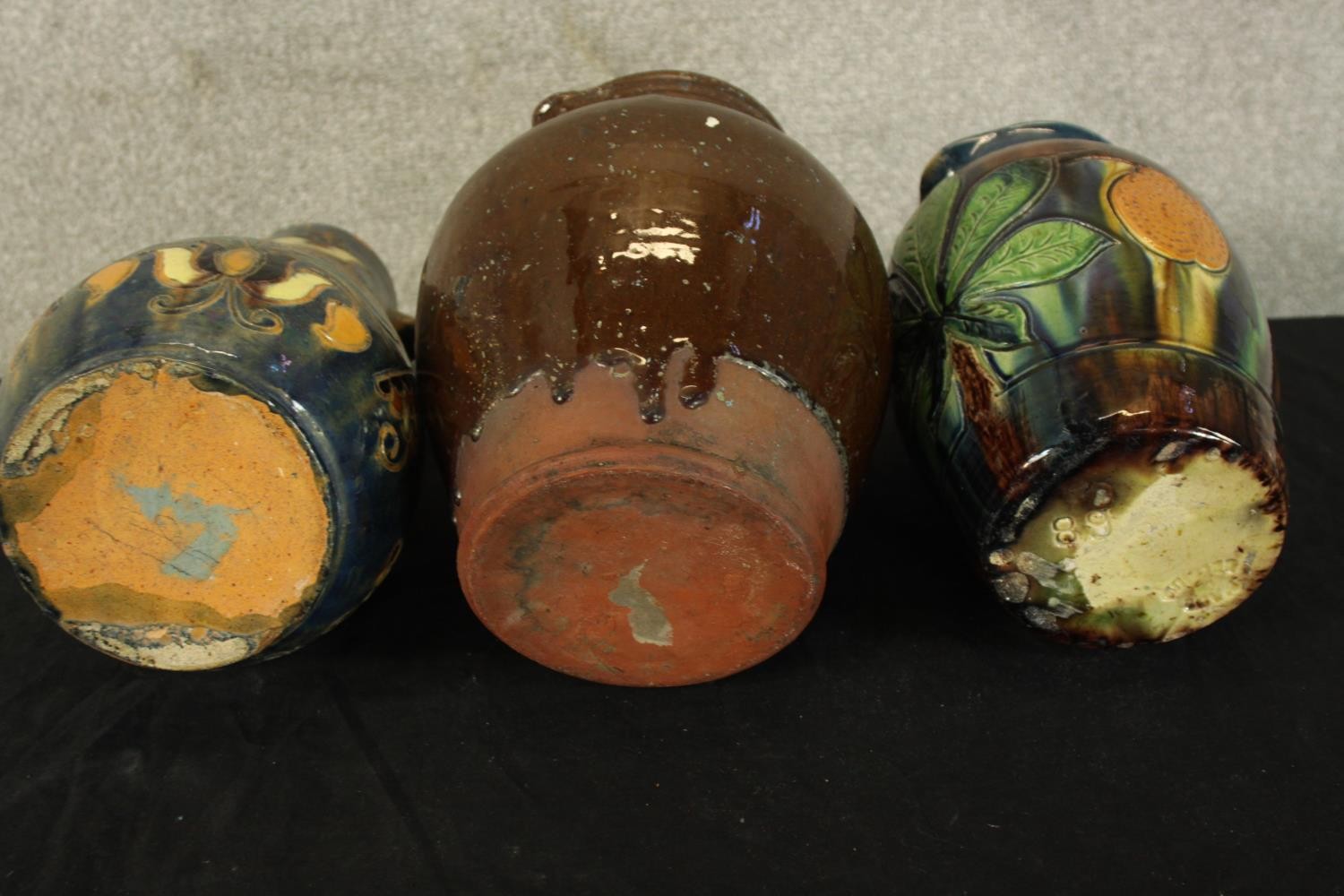 Three studio pottery jugs. Two with a floral decoration. H.30cm (largest). - Image 5 of 5