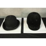 Bowler hat made by Gieves, London. With adjustable band. Also, a horse riding helmet.