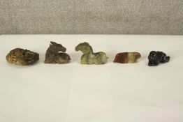 A collection of five Chinese jade, soapstone and hardstone carvings, including a horse, a ram, a