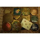 A collection of fourteen makeup compacts. One in the shape of a fan with with a Chinese design