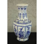A Chinese style blue and white vase. Hand painted and octagon shaped. With the makers sticker on the