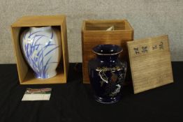 Two boxed Japanese vases, one hand decorated with irises with artist's seal to the base. H.27cm (