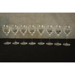 A set of eight cut crystal wine glasses. The highest measures 20 cm.