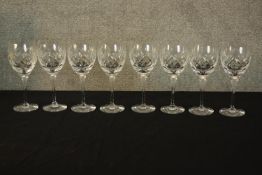 A set of eight cut crystal wine glasses. The highest measures 20 cm.