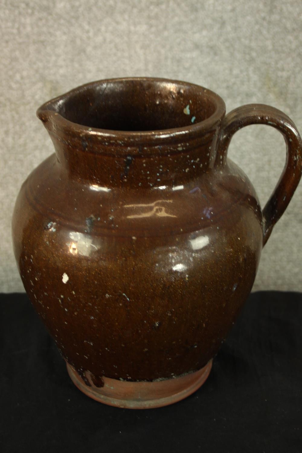 Three studio pottery jugs. Two with a floral decoration. H.30cm (largest). - Image 3 of 5