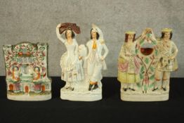 Three flat backed Staffordshire figures. Hand painted porcelain. The highest of the three measures