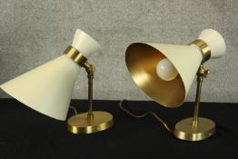 A pair of table lamps in a white and gold finish. Probably Italian. Each H.31 x. W.27cm.