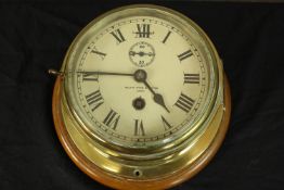A 19th century brass cased ship's clock with white enamel dial stamped Kelvin White and Sutton. With