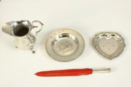 A miscellaneous collection of hallmarked silver to include a cream jug, two pin trays and a paper