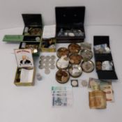 A large collection of world coins and notes, including nine commemorative Churchill crowns.
