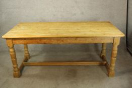 A 19th century pine refectory style dining table. H.76 W.183cm.