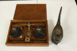A cased set of scales and a small oil can. The largest measures H.23 x W.17 cm.