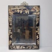 A 19th century lacquered Japanese wall mirror with floral and figural design.