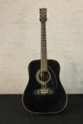 A vintage Eko acoustic guitar in a black lacquered finish. L.110cm.