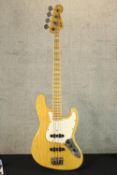 Fender Jazz Bass guitar, made in Japan. In a natural wood finish. Circa 1996-97. Serial No. V021551.