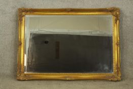 Wall mirror, contemporary in antique style with bevelled plate. H.75 W.104cm.