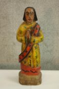 A hand carved wooden sculpted praying figure. Hand painted. Naive in style. H.44cm