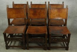 Dining chairs, a set of six vintage oak with leather backs and seats in the Jacobean style.