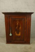 A 19th century corner cupboard inlaid with a bishop in ebony and satinwood. H.98 W.82cm.