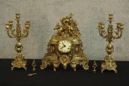 A Rococo style clock garniture with Roman numerals to an enamel dial to include a pair of five