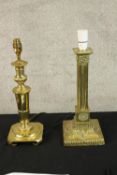 A vintage Corinthian column style brass table lamp base along with another brass table lamp base.