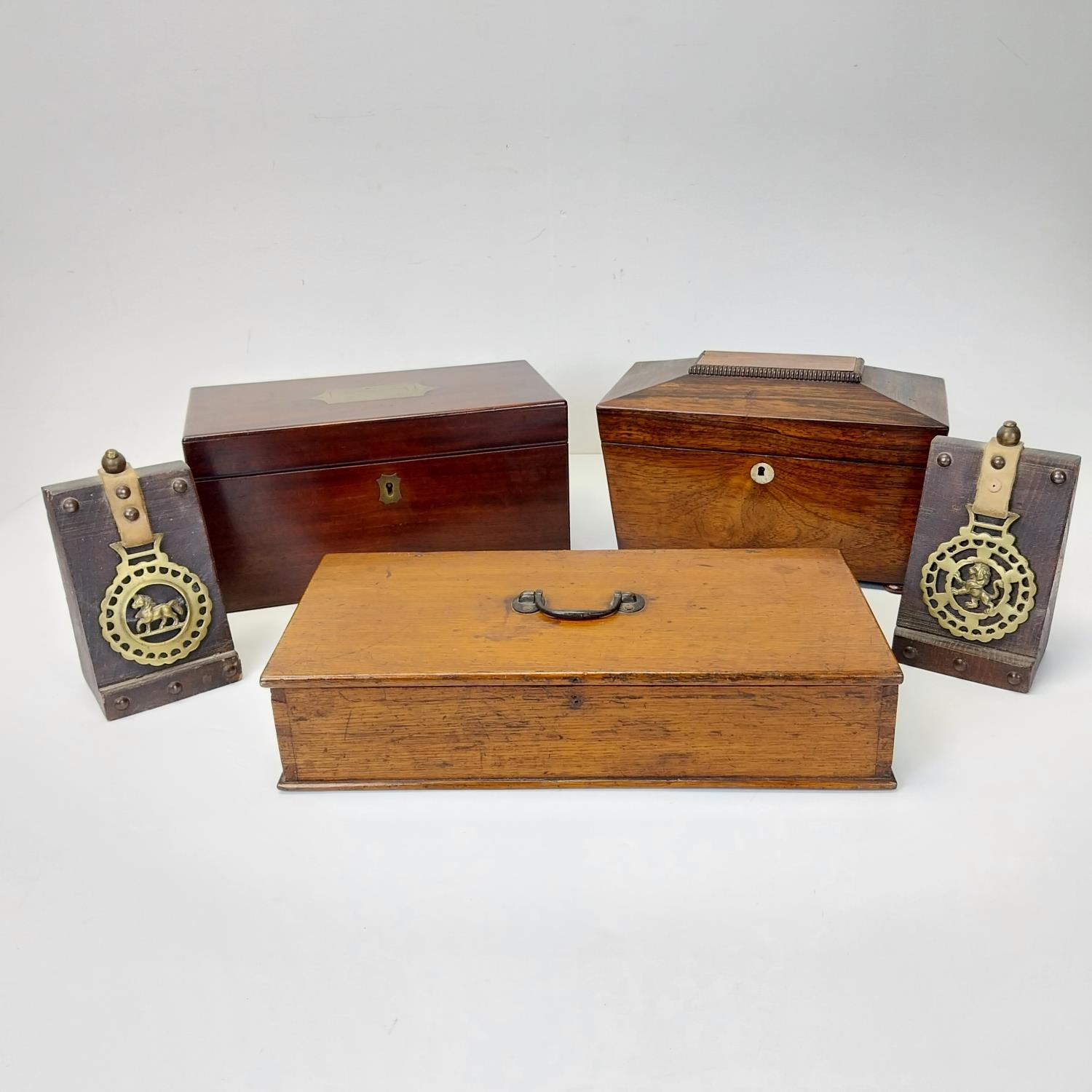 Three 19th century veneered boxes, two tea caddies along with a pair of horse brass book ends.