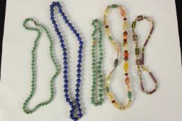 A collection of five necklaces. Two made from jade. The largest measures L.33 cm.