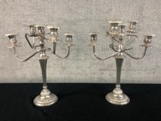 A pair of silver plated five branch candelabras. H.43cm. (each)