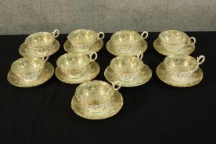 A set of tea cups and saucers. Decorated in gilt and a delicate floral pattern. Each with a diameter