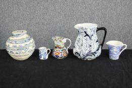 A mixed collection of four jugs and a pot. Including a modern lidded studio ginger jar. The