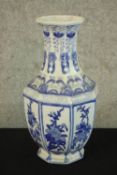 A Chinese style blue and white vase. Hand painted and octagon shaped. With the makers sticker on the