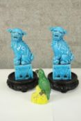 Two ceramic hand painted Feng Shui Beijing lions or maybe Foo dog statues. Also a parrot. H.19cm.